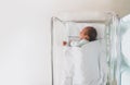 Newborn baby sleeping in hospital room after delivery. First days life of baby after birth Royalty Free Stock Photo