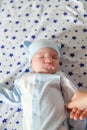 A newborn baby is sleeping. under the stars. against the diaper of the stars. Newborn baby boy lying on bed, sleeping, close up Royalty Free Stock Photo