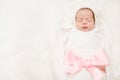 Newborn Baby Sleeping On White, New Born Girl Wrapped With Ribbon Bow Royalty Free Stock Photo