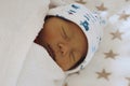 A newborn baby sleeping, wrapped up in swaddling blanket Royalty Free Stock Photo