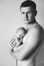 A young dad holds his newborn baby in his arms. Royalty Free Stock Photo