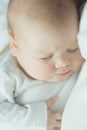 Newborn baby sleeps in the arms of a parent. portrait of infant. soft tinted