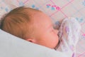 A newborn baby sleeps sweetly on its side, throwing a handle covered with a blanket. View from above Royalty Free Stock Photo