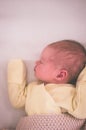 A newborn baby sleeps sweetly on its side, throwing a handle covered with a blanket. View from above Royalty Free Stock Photo