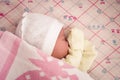 A newborn baby sleeps sweetly on its side, throwing a handle covered with a blanket. View from above Royalty Free Stock Photo