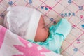 A newborn baby sleeps sweetly on its side, throwing a handle covered with a blanket. View from above Royalty Free Stock Photo