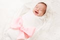 Newborn Baby Smile, New Born Girl Smiling Wrapped by Ribbon Bow Royalty Free Stock Photo