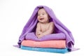 Newborn baby smiling lying on a stack of towels Royalty Free Stock Photo
