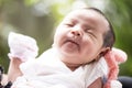 Newborn baby smiling in mother`s hands, selective focus in her eyes, Family concept Royalty Free Stock Photo
