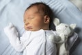 Newborn baby with a soft toy bunny