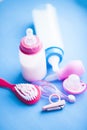 Newborn baby story. Children's toys, scissors, baby bottle, nipple, hairbrush on blue background Royalty Free Stock Photo