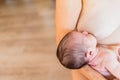 Newborn baby sucking breastfeeding from his mother`s breast Royalty Free Stock Photo