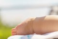 A newborn baby sunbathes in the sun. Health, treatment, dermatology, childhood, summer, rest, walks. little baby foot