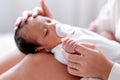 Newborn baby with teat was put on her mother knees who sit on bed and  also take care with love Royalty Free Stock Photo