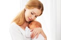Newborn baby in tender embrace of mother Royalty Free Stock Photo