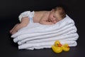 Newborn baby on top of towels