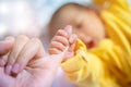 Newborn baby touching his mother hand.