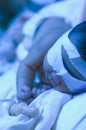 Newborn baby under ultraviolet light Royalty Free Stock Photo