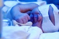 Newborn baby under ultraviolet light Royalty Free Stock Photo