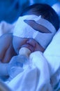 Newborn baby under ultraviolet light Royalty Free Stock Photo