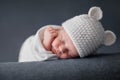 Newborn baby 2 weeks old sleeping on soft blue fluffy blanket