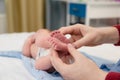 Newborn baby& x27;s legs in mom& x27;s hands Royalty Free Stock Photo