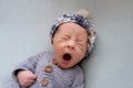 Newborn baby yawns, white background, copy space. Sleep sippers, funny face of a child, emotions. daily routine, time to Royalty Free Stock Photo