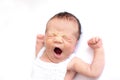Newborn baby yawns, white background, copy space. Sleep sippers, funny face of a child, emotions. daily routine, time to sleep Royalty Free Stock Photo