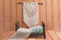 Newborn background - wooden bed with rustic throw and macrame