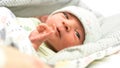 A newborn beautiful baby look at the camera.