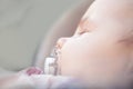 Newborn Beautiful Baby with nipple Sleeping