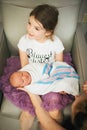 Newborn being held by big sister Royalty Free Stock Photo