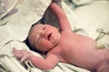 Newborn after birth with umbilical cord lies Royalty Free Stock Photo