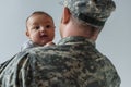 newborn boy in arms of serviceman