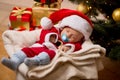 Newborn boy sleeping in living room at Christmas tree and boxes Royalty Free Stock Photo