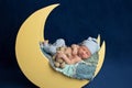 Newborn Boy Sleeping on the Moon with Teddy Bear Royalty Free Stock Photo