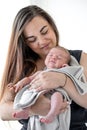 A newborn boy sleeps sweetly in his mother`s arms, wrapped in a blanket Royalty Free Stock Photo