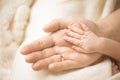 Newborn child hand. Closeup of baby hand into parents hands. Family, maternity and birth concept. Royalty Free Stock Photo