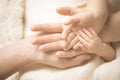 Newborn child hand. Closeup of baby hand into parents hands. Family, maternity and birth concept. Royalty Free Stock Photo