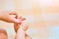 Newborn child holds a mother`s finger, close-up concept love. Hands of mother and baby closeup. The Touching Lovely Moment. Royalty Free Stock Photo