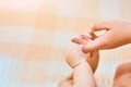 Newborn child holds a mother`s finger, close-up concept love. Hands of mother and baby closeup. The Touching Lovely Moment. Royalty Free Stock Photo