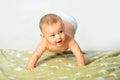 Newborn child relaxing in bed. Happy baby playing. Beautiful expressive adorable happy cute laughing smiling infant Royalty Free Stock Photo