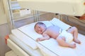 Newborn child under ultraviolet lamps