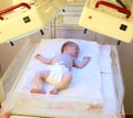 Newborn child under ultraviolet lamps