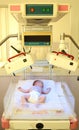 Newborn child under ultraviolet lamps