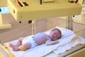 Newborn child under ultraviolet lamps