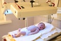 Newborn child under ultraviolet lamps