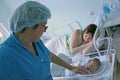 Newborn child and young mother in a maternity hospital