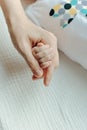 Newborn children`s hand in mother hand. Mom and her Child. Happy Family concept Royalty Free Stock Photo