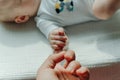 Newborn children`s hand in mother hand. Mom and her Child. Happy Family concept Royalty Free Stock Photo